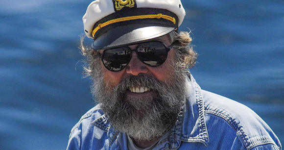 ken on the Salish Sea in a captains hat