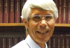 portrait of Michael Tillman in front of books
