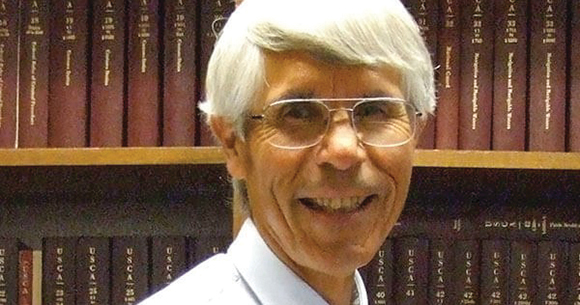 portrait of Michael Tillman in front of books