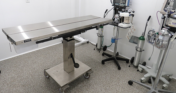 an x-ray table and other equipment in a surgical room