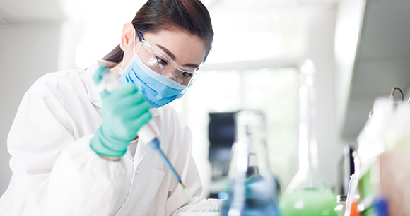 scientist works with syringe in lab