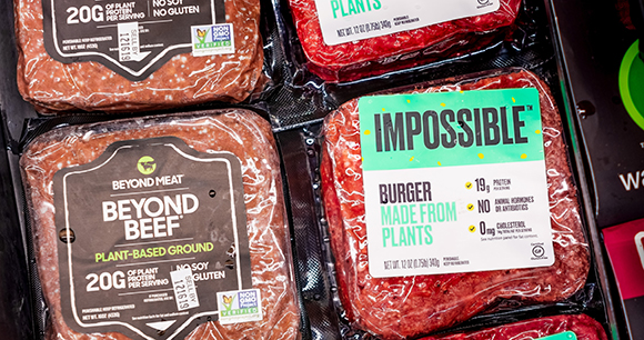 beyond beef and impossible burger ground beef in a grocery store freezer