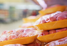 Raw chicken legs on a supermarket shelf