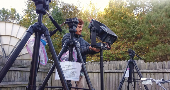 Researcher Sets up camera and speaker array