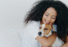 woman embraces dog in the home
