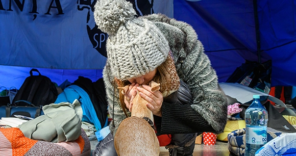 a displaced woman and her dog in Ukraine