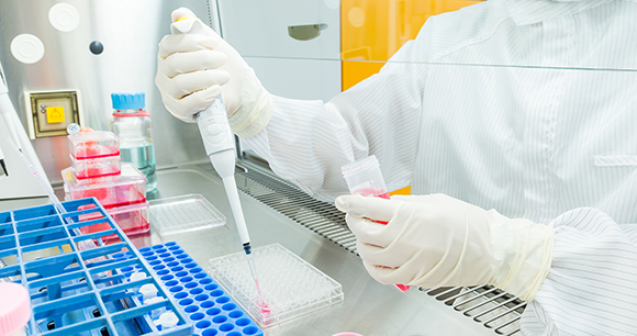 A scientist creating a chemical assay to conduct a molecular experiment.