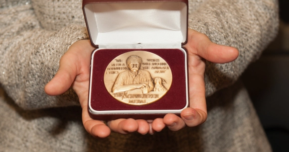 the Albert Schweitzer Medal is displayed held in two hands