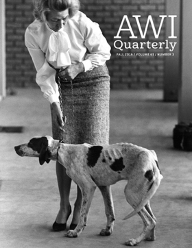 woman pulls dog by leash near lab