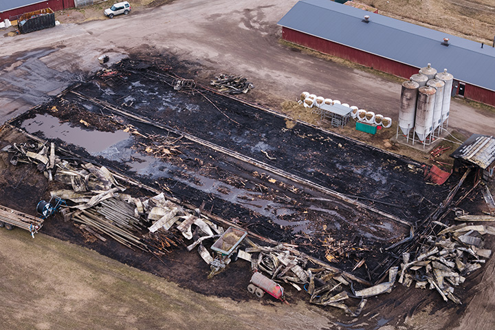 a large barn flattened by a fire